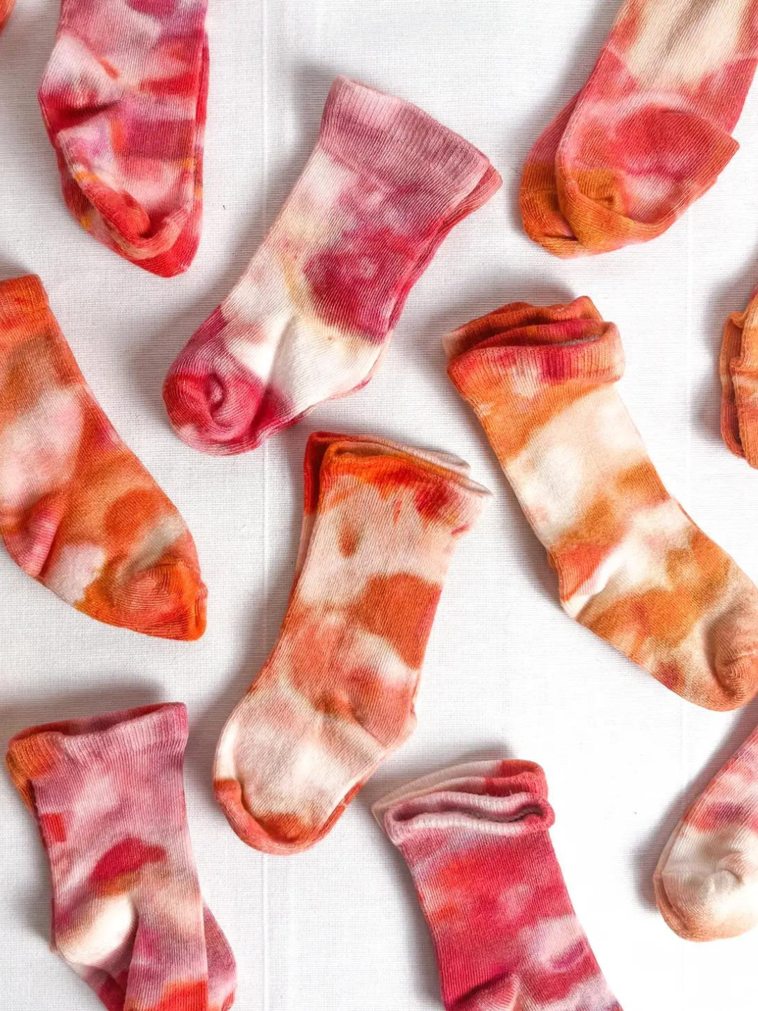 Golden Hour | Multiple pairs of baby ankle socks in dappled shades of orange, pink and white