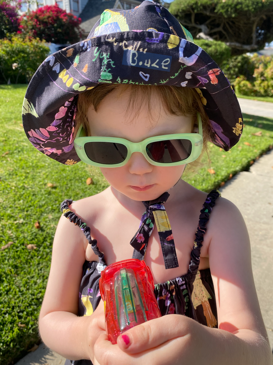 Mint Frosted | A child wearing a pair of mint green kids' sunglasses with blue lenses