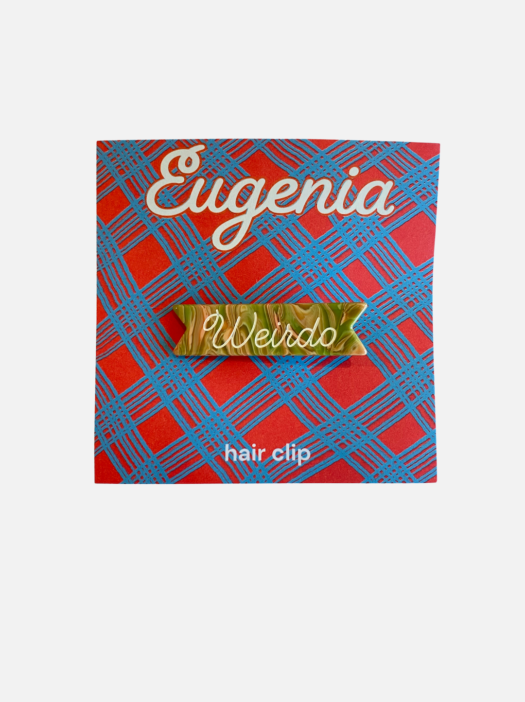 A presentation card for a kids' hair clip with the word Weirdo against a swirly green and orange background