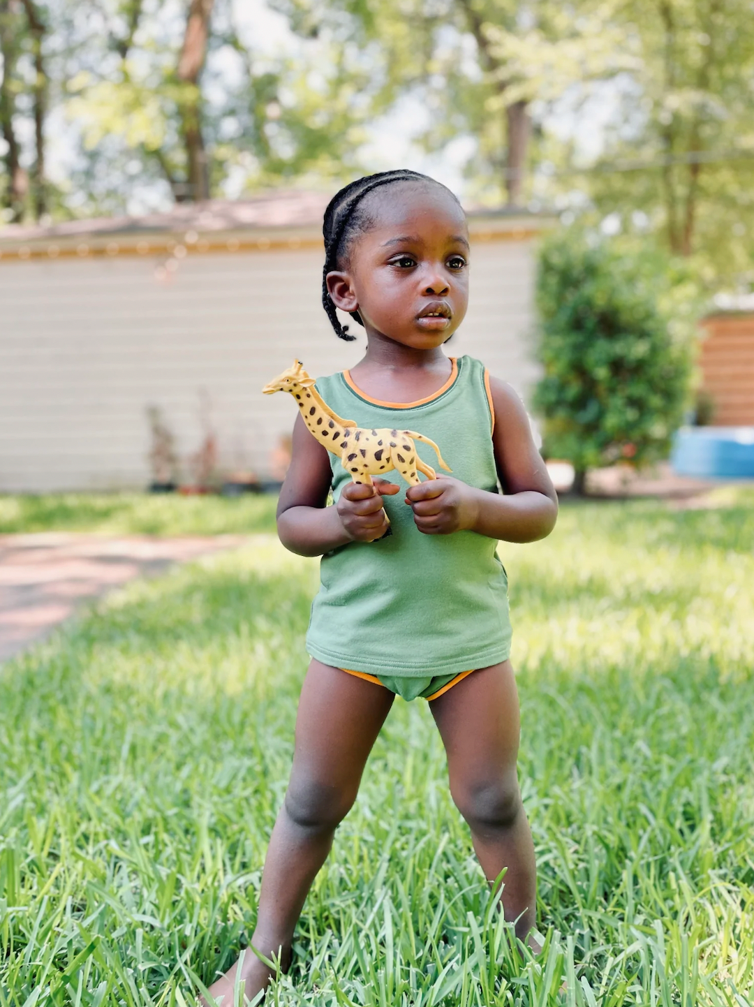 Mint | Child wearing mint green kids' tank and bloomers with yellow trim at neck, arm and leg holes