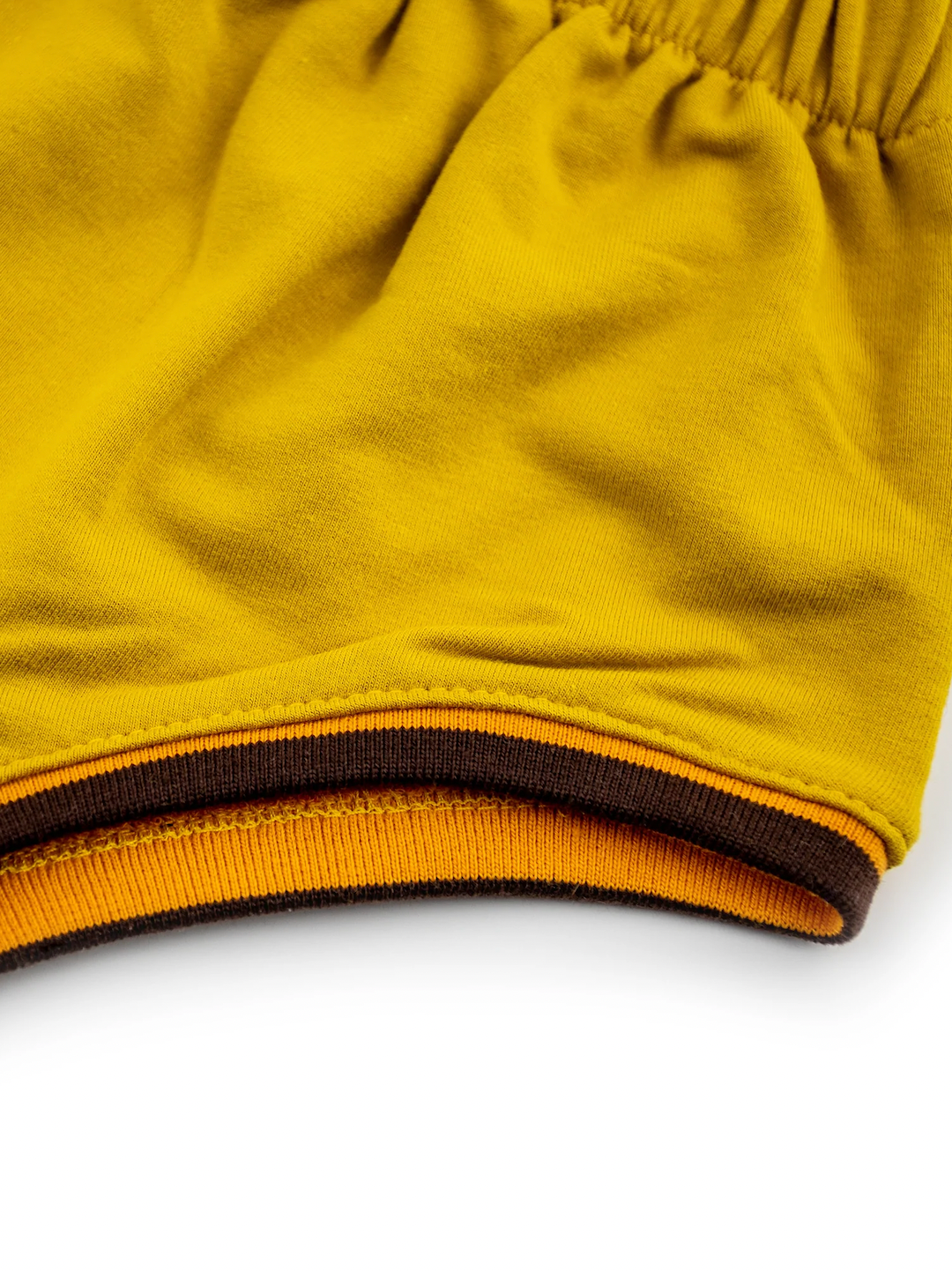 Sunshine | Detail of black trim on leg hole of kids' sunshine yellow bloomers