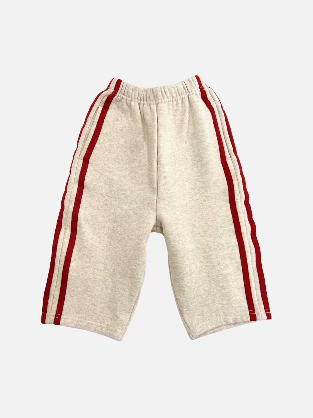 A front view of the kid's Varsity Pant in Oatmeal with red stripes on the sides.