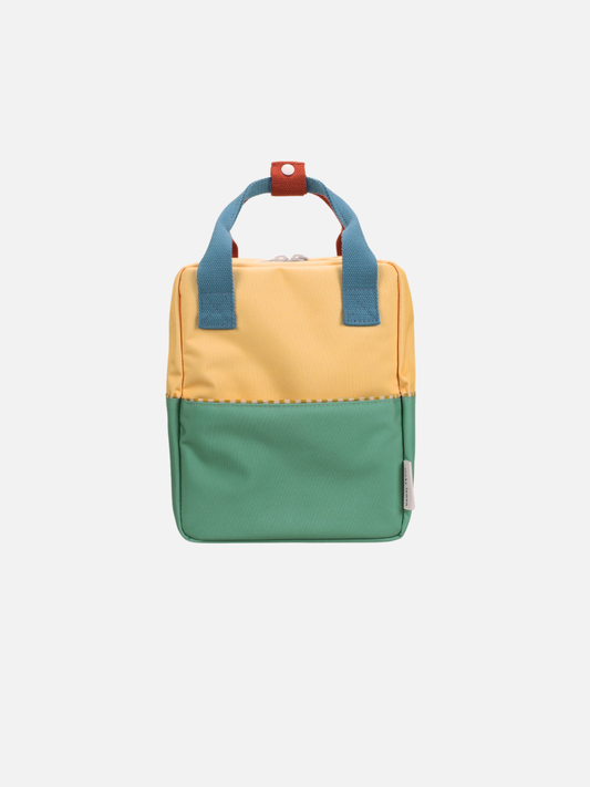 Image of Sandy Yellow/Aquatic Green | The SMALL COLOURBLOCKING BACKPACK, made from recycled PET bottles, features a sandy yellow top, aquatic green bottom, blue handles, red snap closure, and waterproof lining—shown against a plain white background.