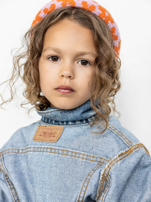 Second image of Ochre Checks | A kids' knitted headband in an ochre and cream check