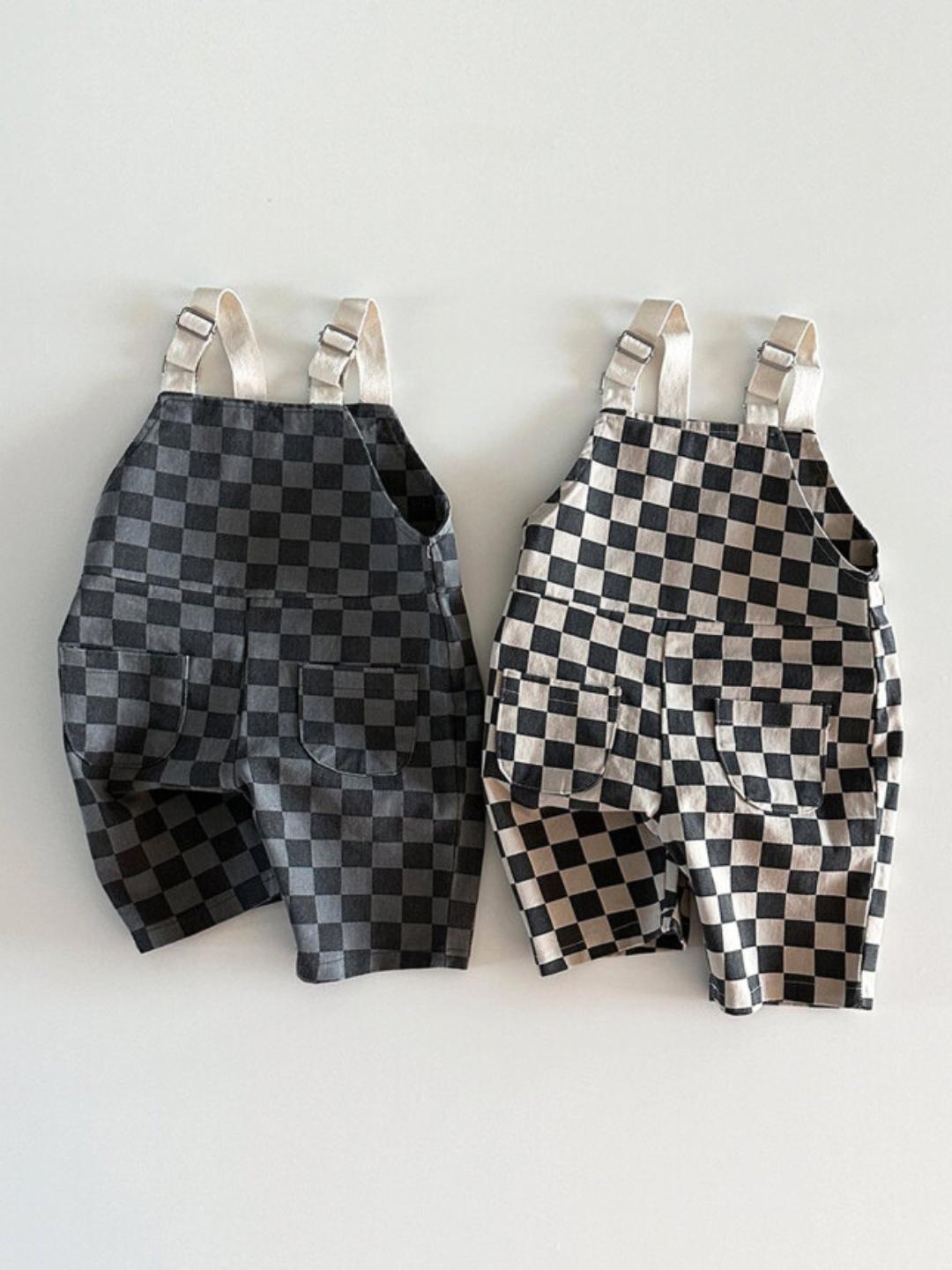 Both colors of pull on checker overalls laid next to each other