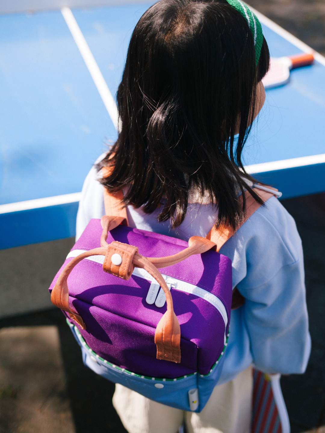 Purple Tights | A child is wearing the Coulorblocking backpack in Purple Tights