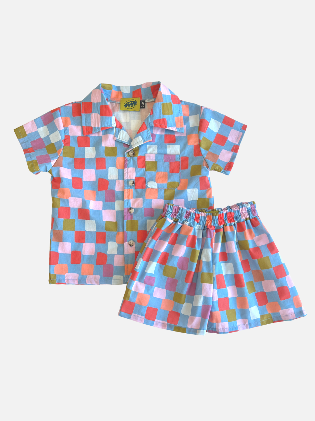 A kids' shirt and short set in a pattern of red, pink, lilac, orange and green squares on a blue background