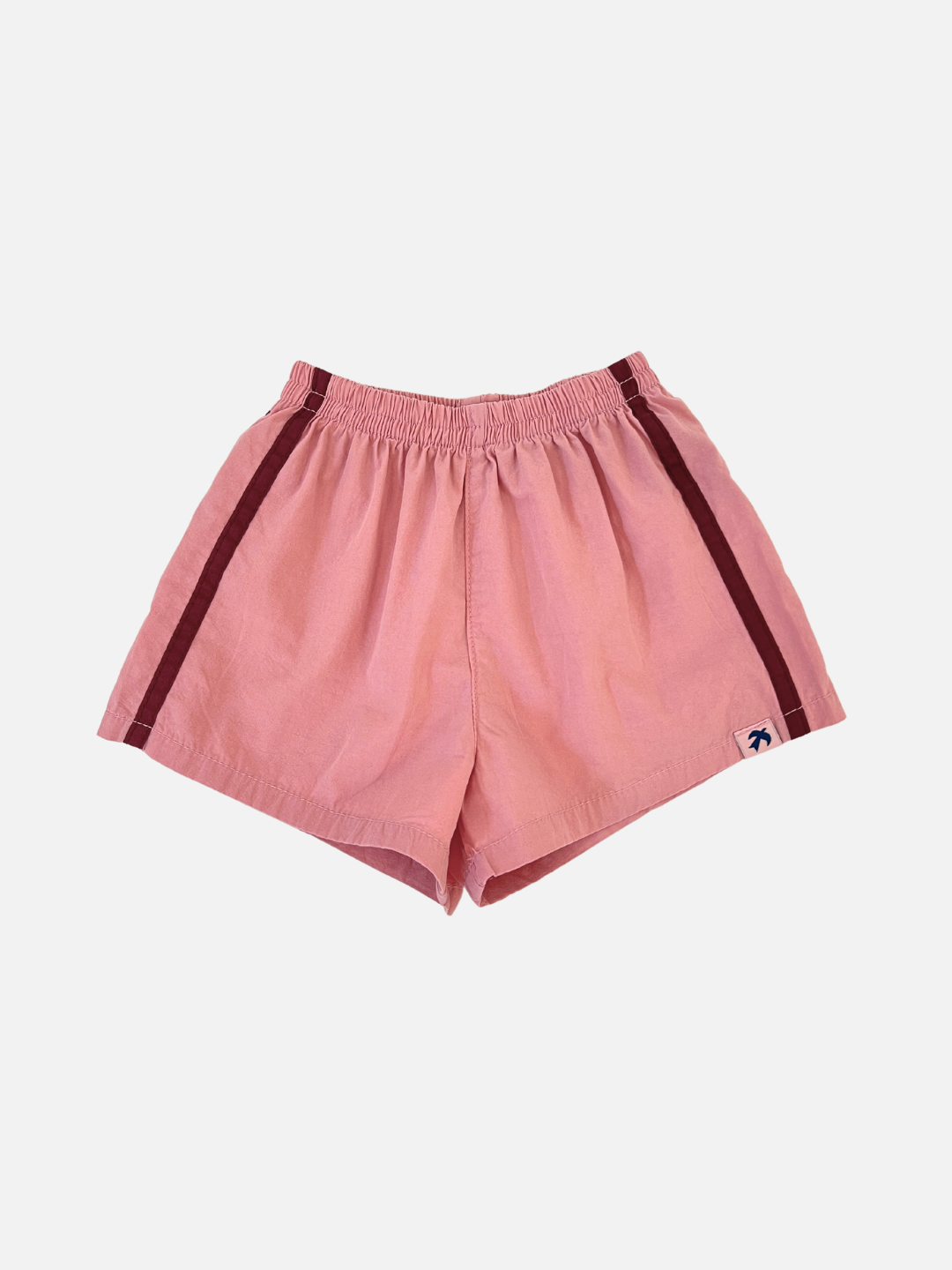Dusty Pink | Front view of the kids' dusty pink shorts with burgundy stripes on the sides. 