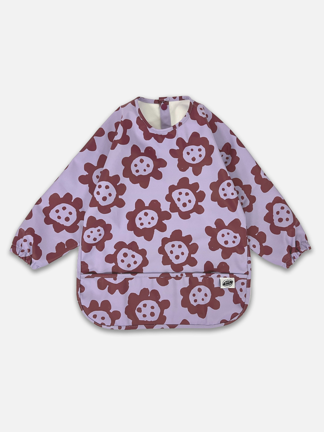 A front view of the long sleeve lavender colored bib with dark purple sunflowers and a front pocket.