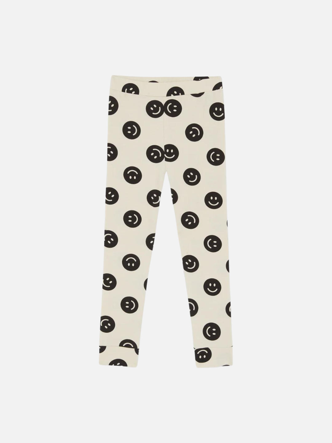 A front view of the cream colored leggings with a black smiley face pattern.