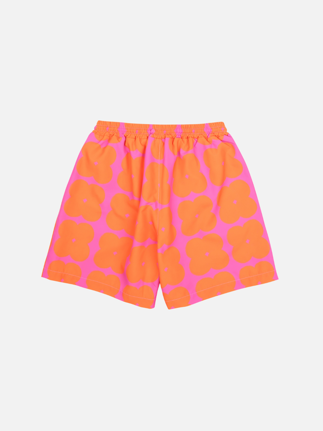 Back of Clover Shorts. Bright orange clover shapes on a bright pink background. Has an elastic waist with a tie and small logo on bottom right corner.