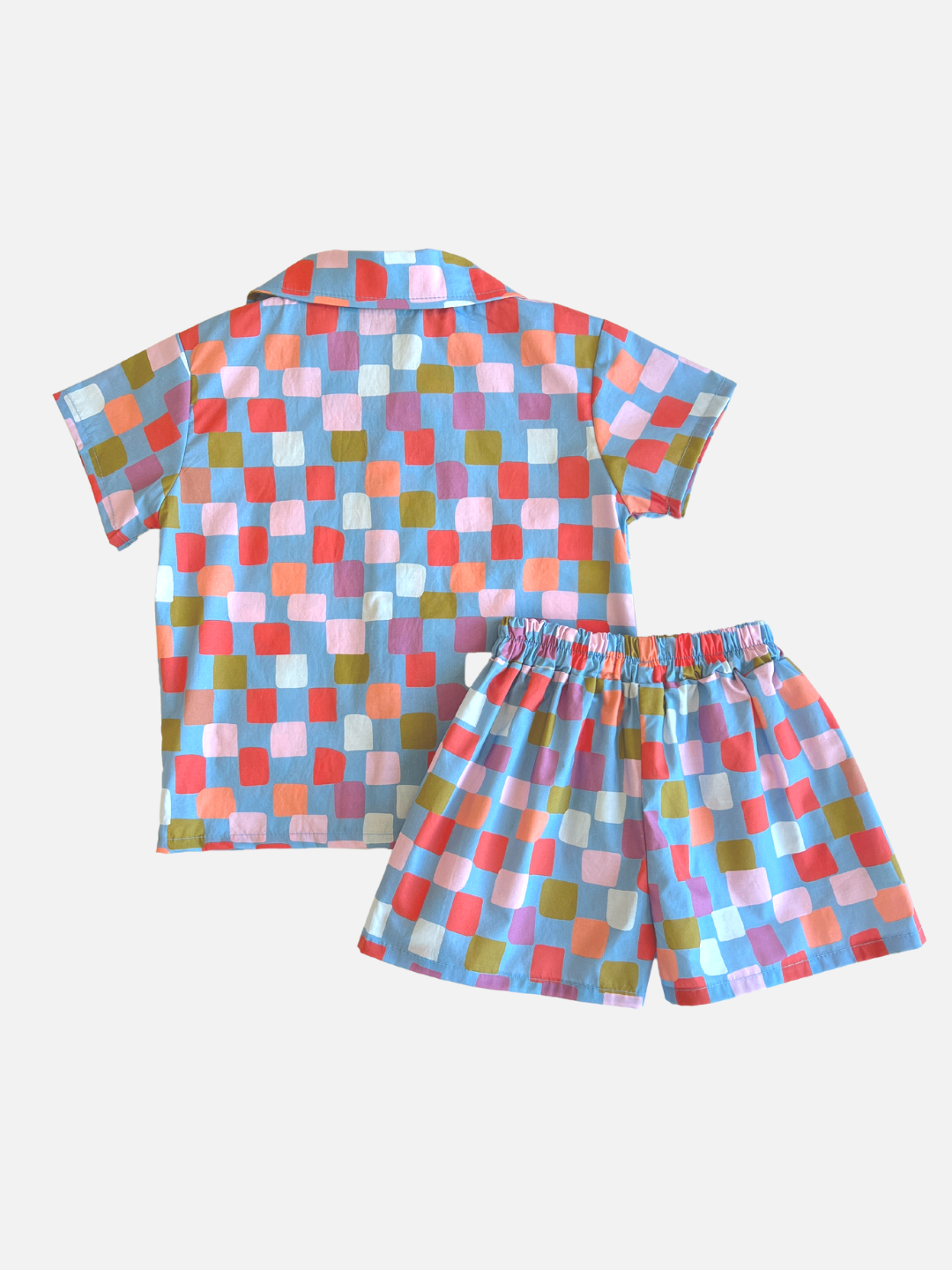 Blue | A kids' shirt and shorts set in a pattern of red, orange, pink, lilac and green squares on a blue background, back view