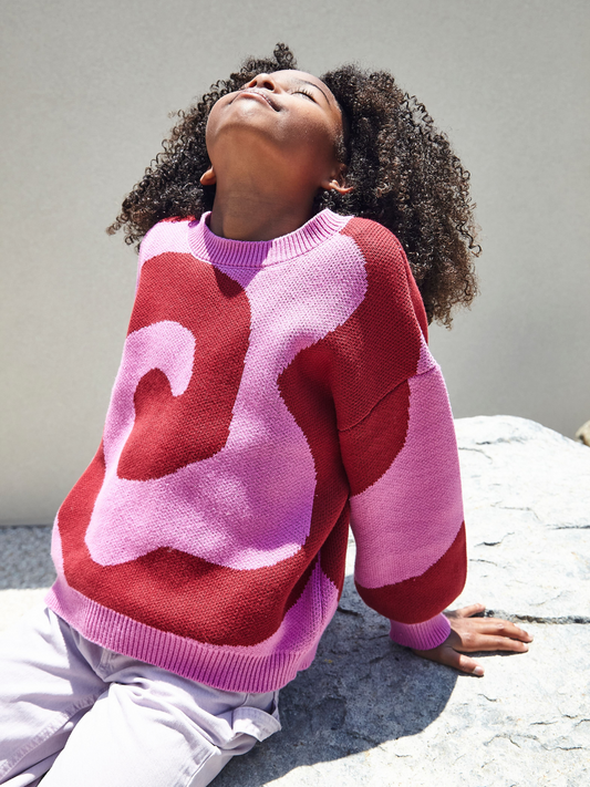 Second image of Raspberry | Front view of kids crewneck sweater in bright pink, with a large single red swirl design that covers the entire sweater.