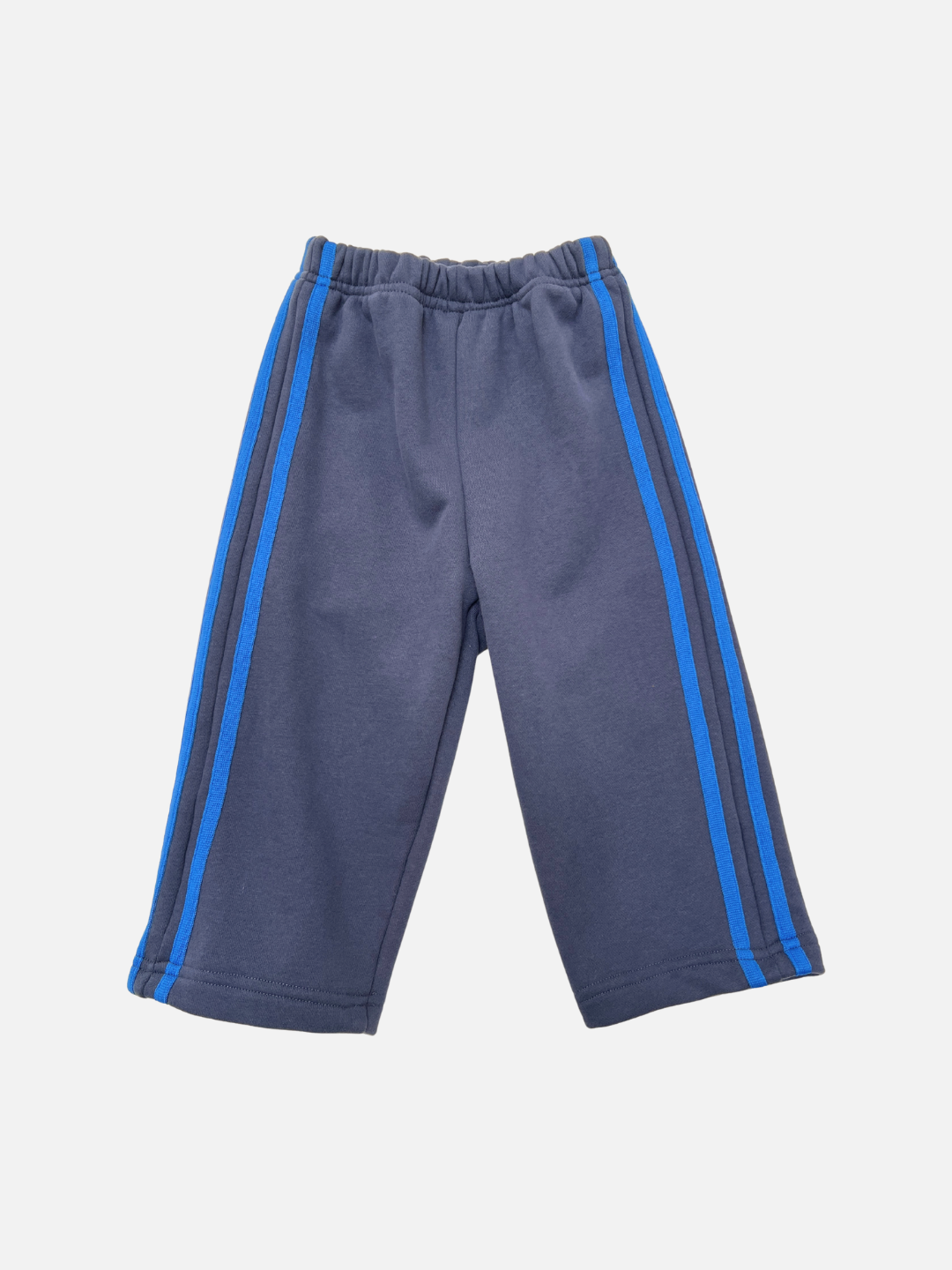 SUNDAY TRACKPANTS in navy, featuring a baggy fit, elastic waistband, and blue side stripes, displayed flat on a white background.