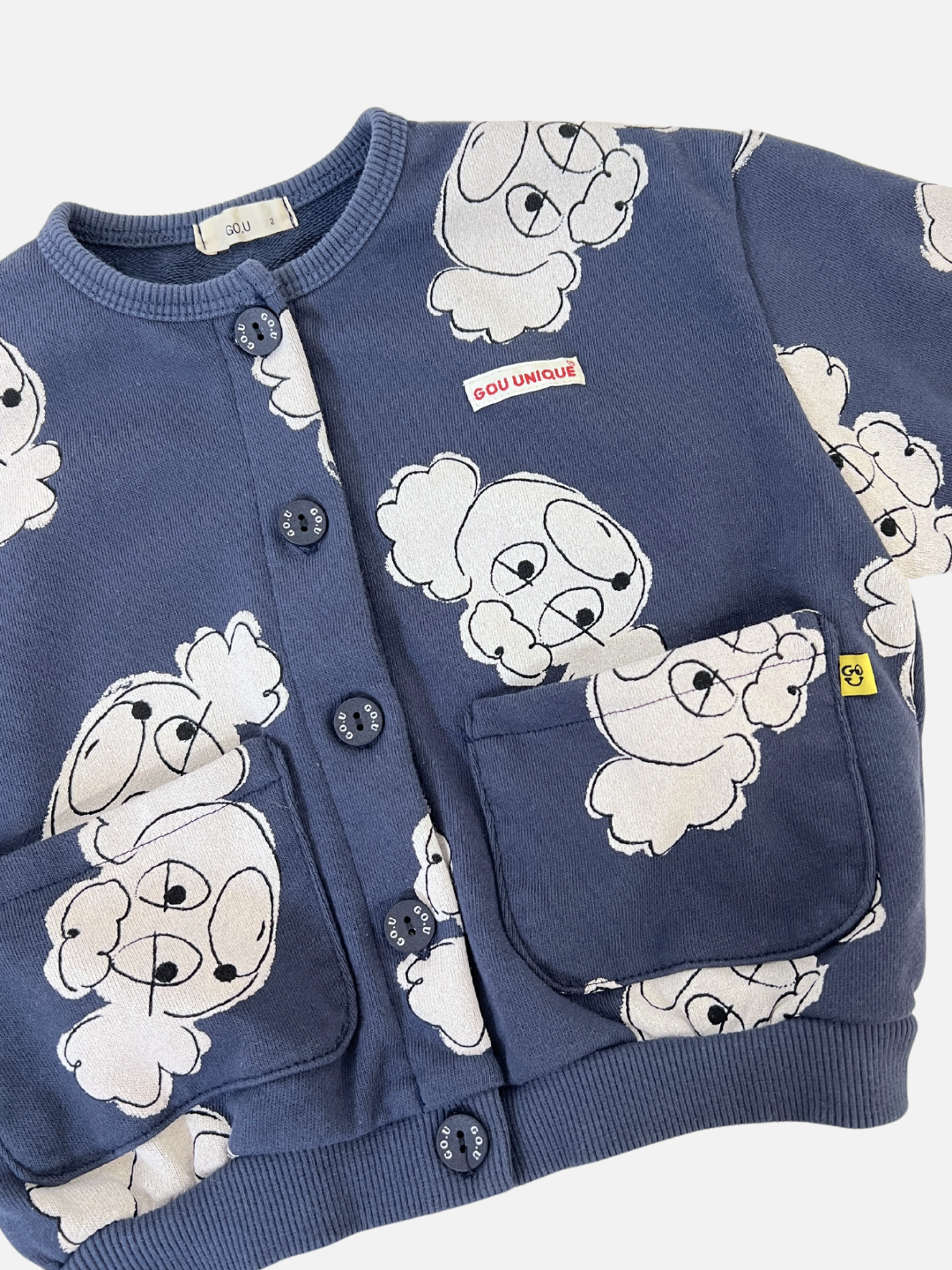 Navy | The POODLE BUTTON DOWN SWEATSHIRT is a blue toddler's cardigan made from soft French terry fabric, featuring playful cartoon dog patterns. It has buttons down the front and two handy pockets, ideal for keeping little hands cozy.