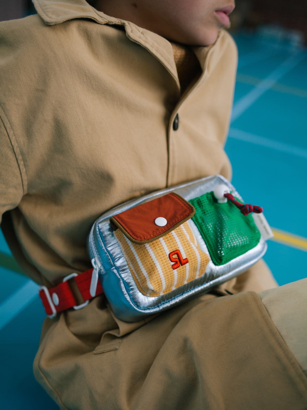 Metallic Blue | A child is wearing a Metallic Blue Bike Bag