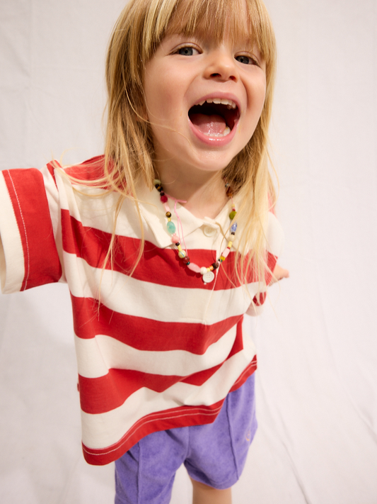 Second image of Red | The RUGBY COLLAR TEE is a short-sleeved, red and white striped polo with a collar and two buttons, made from 100% cotton by a popular Korean kids brand, shown laid flat on a white background.