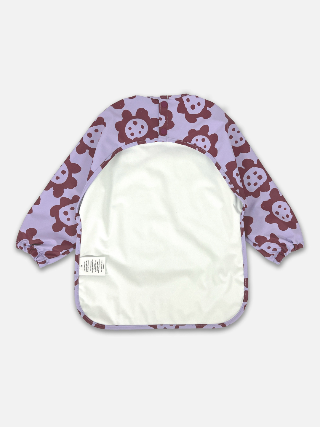 Back View of the long sleeve lavender colored bib with dark purple sunflowers  and a back cut out with two buttons for closure.