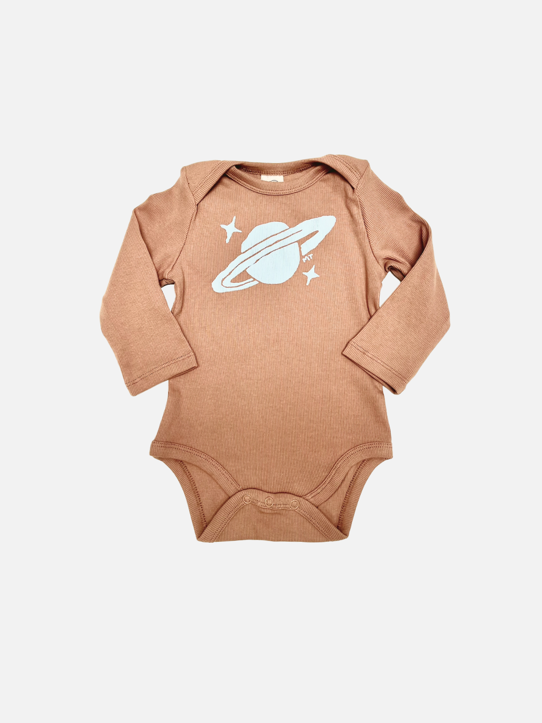 The SATURN LONG SLEEVE ONESIE is a brown, ribbed cotton baby bodysuit with a white Saturn and two stars graphic on the chest, shown flat on a white background—ideal for easy diaper changes.