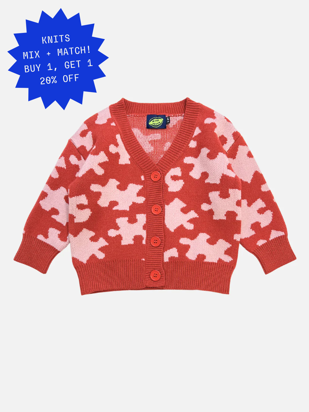 Red | The PUZZLE CARDIGAN in red features a puzzle piece pattern, button-up front, long sleeves, and ribbed cuffs and hem. Displayed on a plain white background.