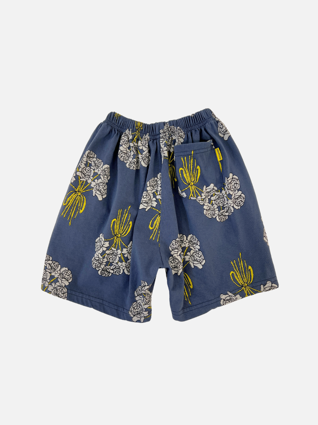 Back view of the kids' Bouquet Shorts. Navy cotton fabric with an all-over white roses bouquet print. Back pocket on the right side.