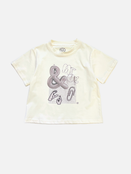 Image of The CLIP ART TEE is a white short-sleeve shirt made from silky cotton, featuring a graphic ampersand and abstract lines on the front—a fresh addition to your Milk Teeth tee collection.