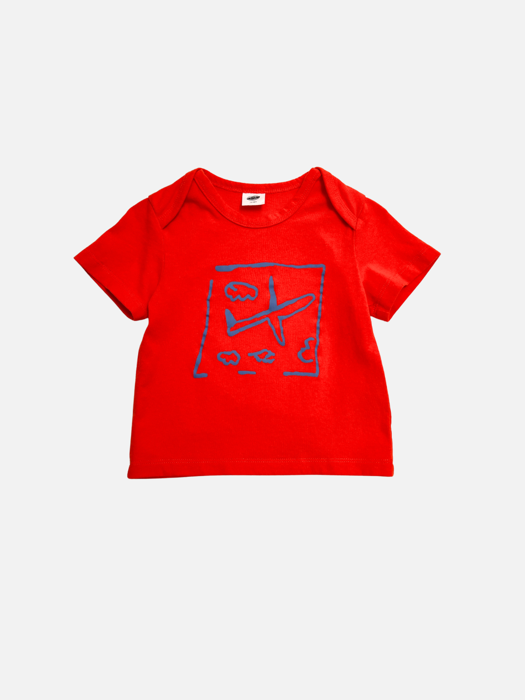 The AIRPLANE BABY TEE is a red toddler shirt with a playful blue airplane, clouds, and birds print on the front—perfect for your little explorer.