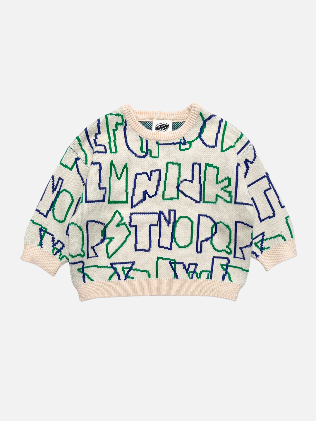 A cream-colored knit kids sweater with a bold, abstract pattern of blue and green alphabet letters, laid flat against a light gray background.