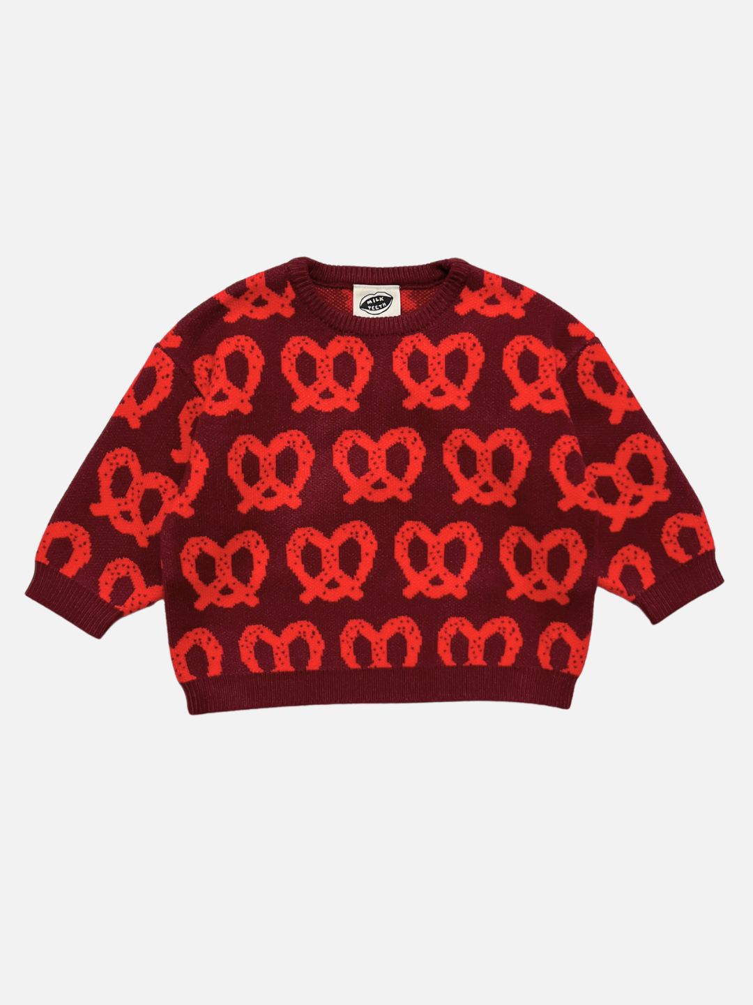 Red | A long-sleeve crewneck sweater featuring an all-over knit pattern of red pretzels on a dark burgundy background, displayed flat against a light gray background.
