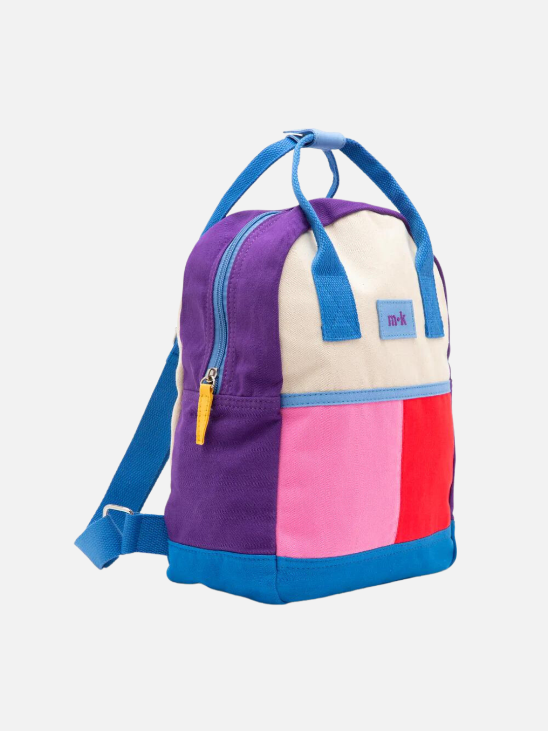 Side view of a colorblock backpack with bright blue straps, handles and base, purple sides, and one pink, one red patch under a cream top