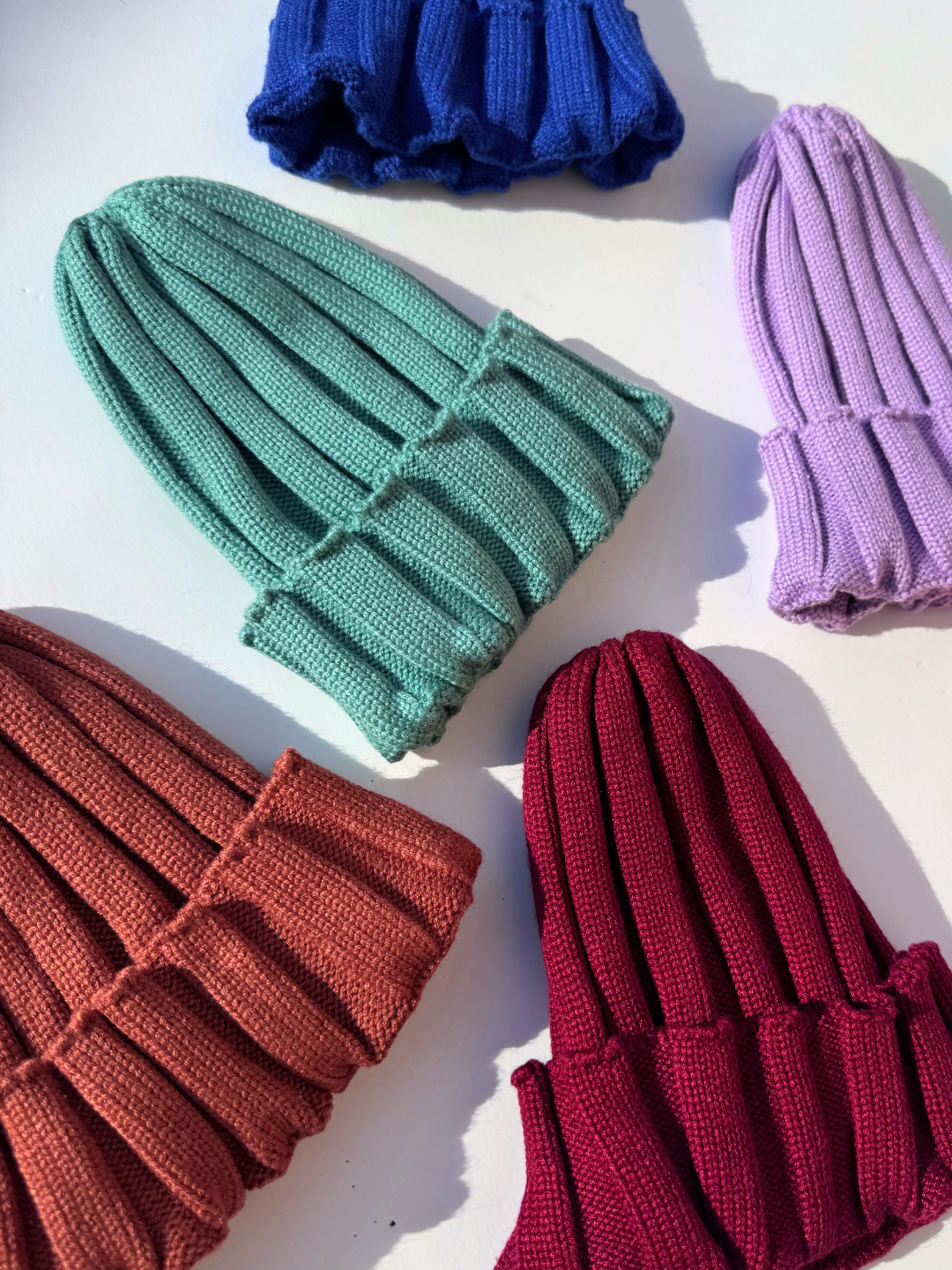 Colorful knitted gloves on a white background