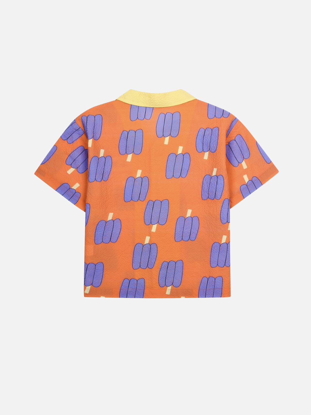 Orange shirt with purple bell pepper pattern on a white background