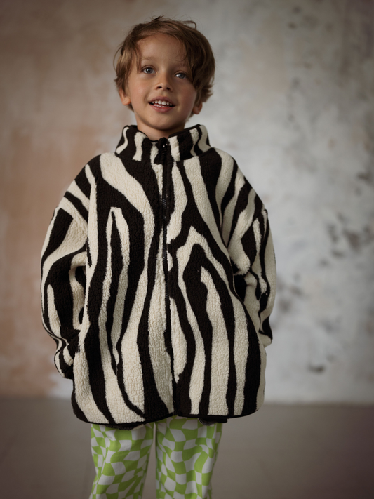 Second image of Kids fleece jacket in a black and cream tiger stripe pattern.