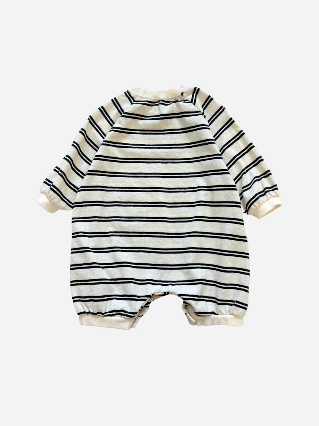 Off-White | The SLOUCHY STRIPE ROMPER is a long-sleeve cotton baby romper with black stripes on an off-white background, inspired by a popular Korean baby brand and shown on a plain white surface.