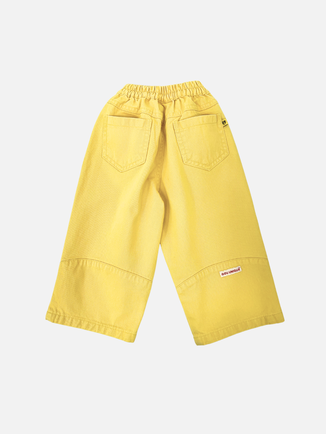 PICKLE PANTS feature a baggy fit with an elastic waistband, crafted from yellow wide-leg cotton twill. They include two back pockets and are displayed on a plain white background.