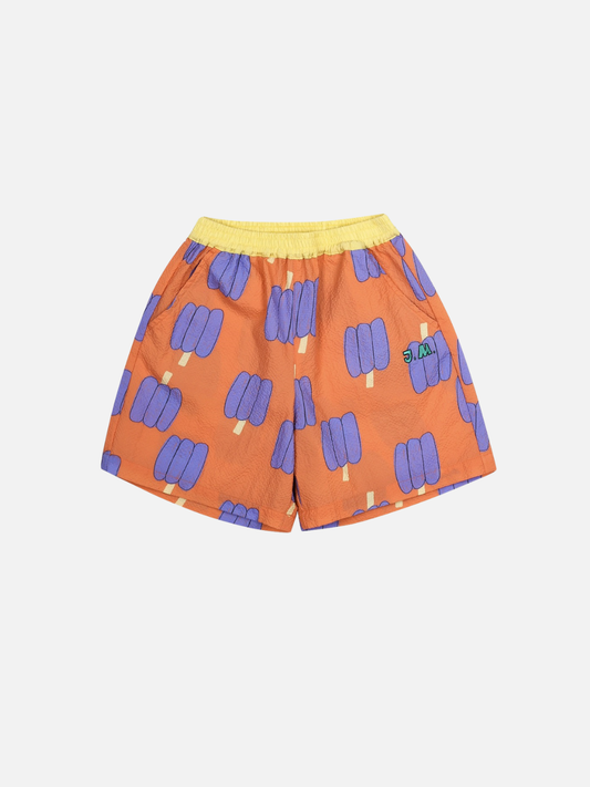 Image of Orange shorts with purple bell pepper pattern on a white background