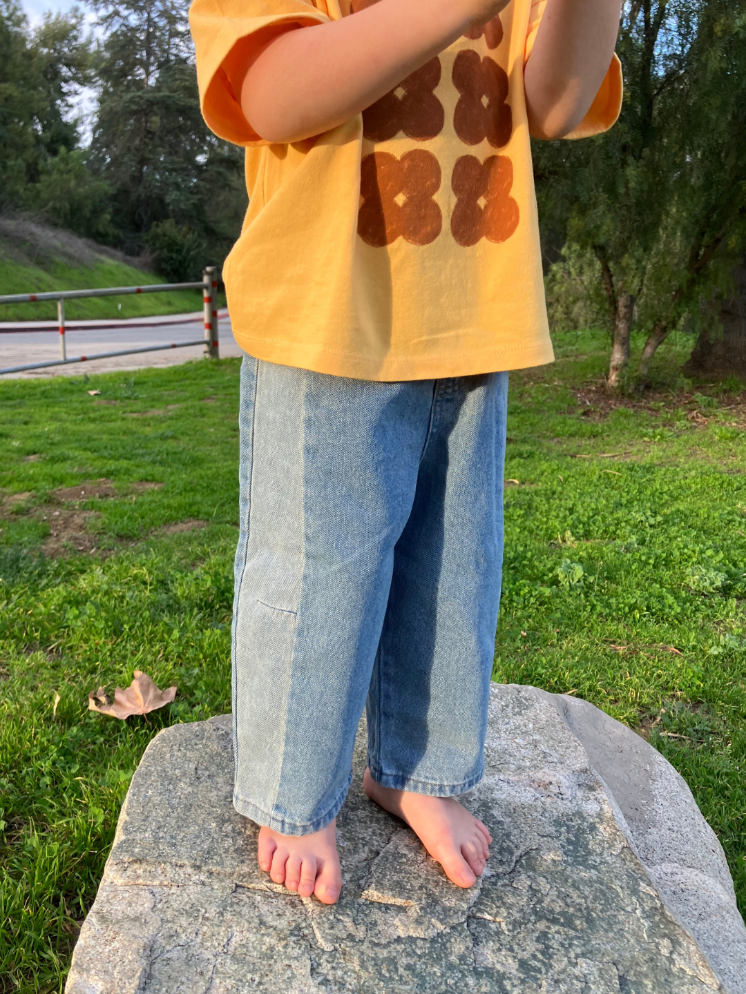 A child is wearing Dart Jeans with a yellow t-shirt