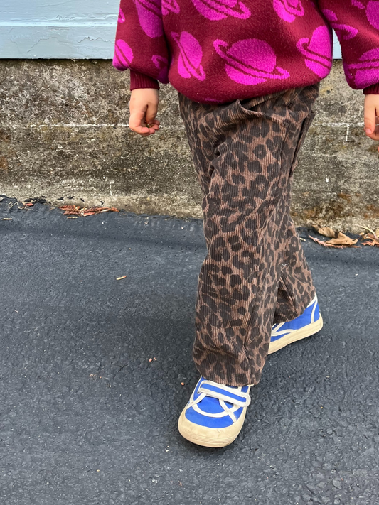 Second image of Brown leopard print cotton corduroy pants with an elastic waistband from the trendy Korean brand, LEOPARD CORDS, laid flat against a white background.