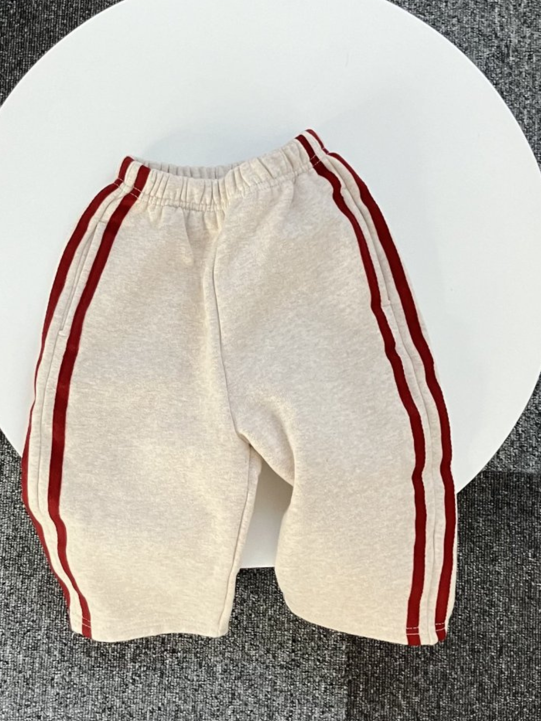 Oatmeal | Kid's Varsity Pant in Oatmeal laid flat on white table. 
