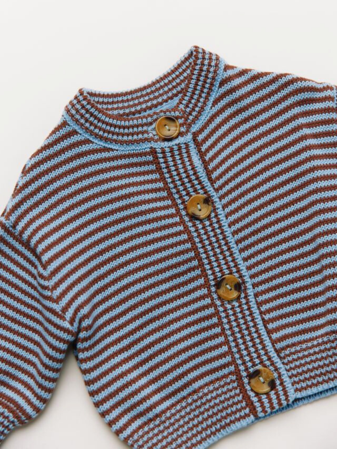 The EMIL COCO SKY STRIPE CARDIGAN features brown and light blue stripes, long sleeves, and four brown front buttons. Displayed flat on a white surface.