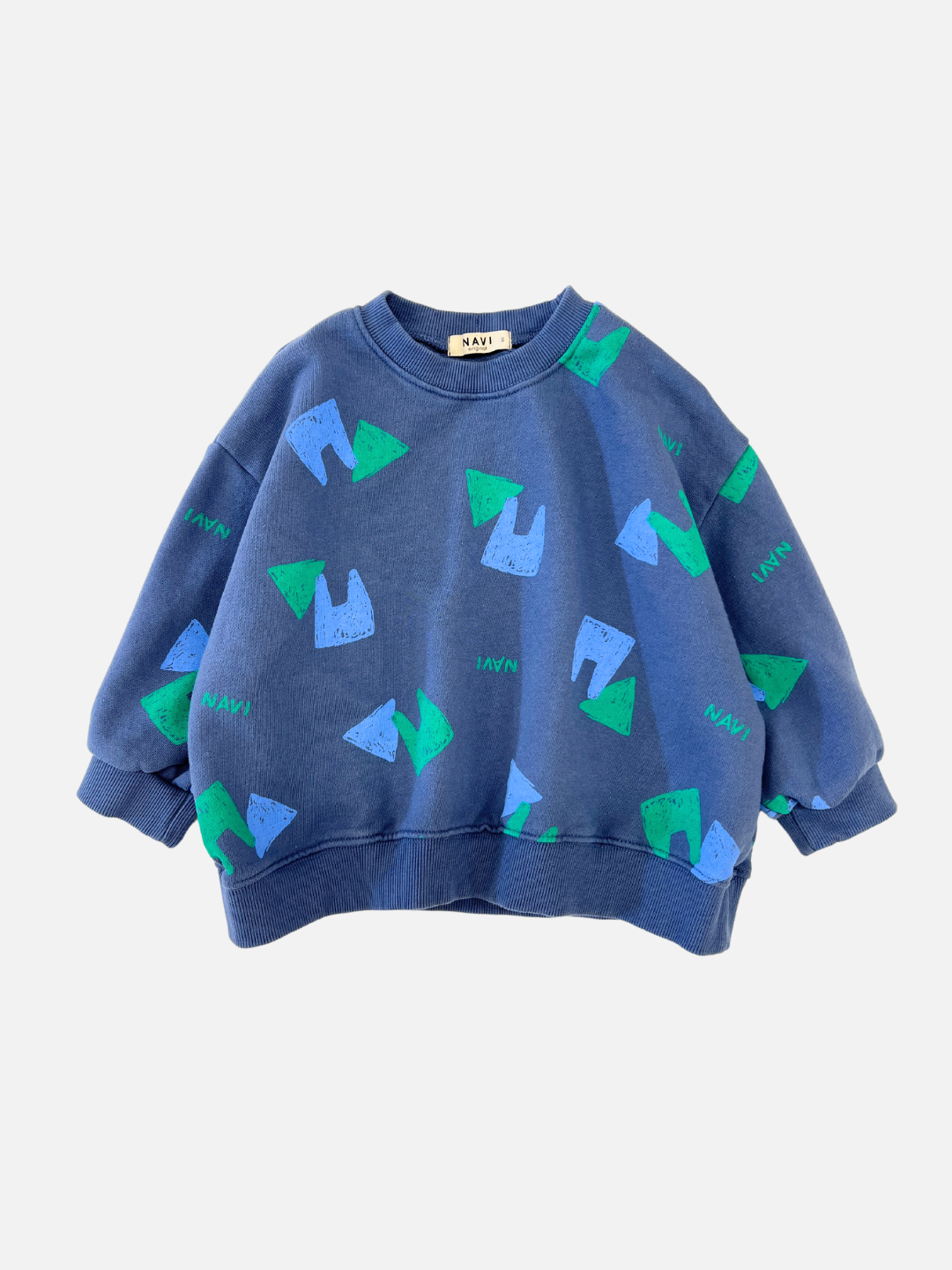 Vintage Blue | Front view of kids blue crewneck sweatshirt with an all over pattern of green and blue shapes and the brand name Navi.