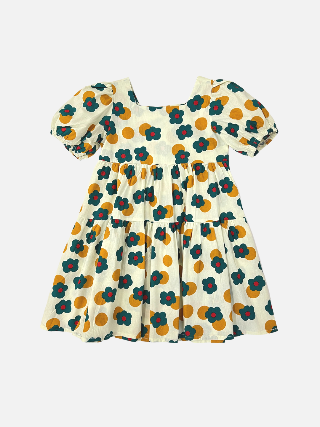 A kids' tiered, puff-sleeved dress with a pattern of green and red flowers and ochre dots on a white background