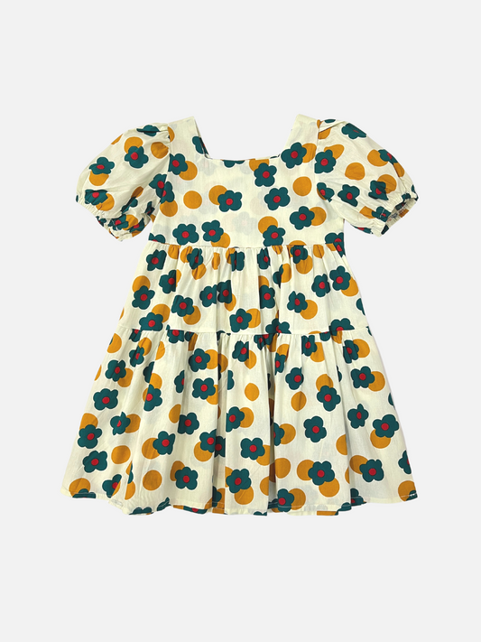 Image of A kids' tiered, puff-sleeved dress with a pattern of green and red flowers and ochre dots on a white background