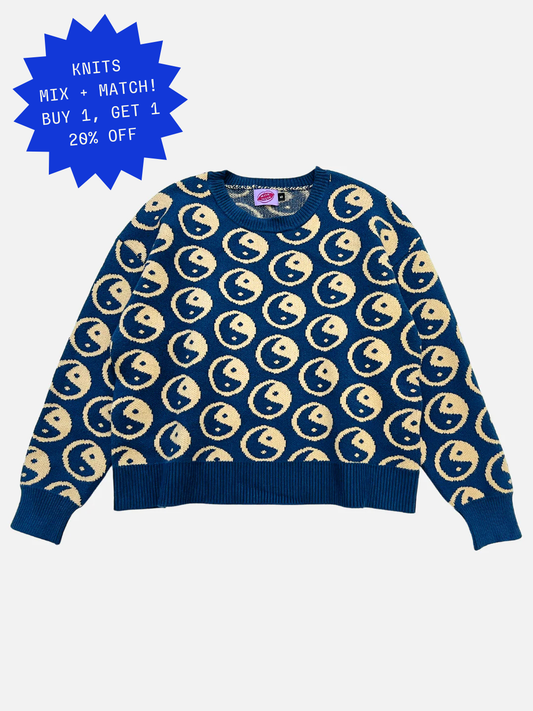 Image of Blue sweater with beige yin yang symbols pattern on a white background