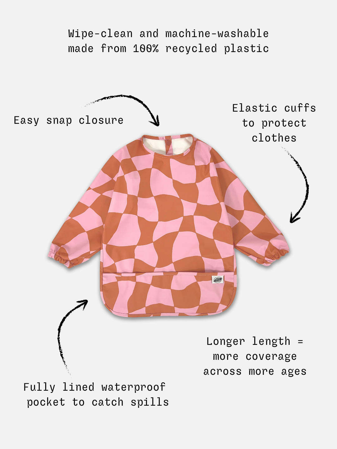 Pink Checkers | Detailed information  of the long sleeve light pink and rust wavy checked bib with a front pocket. 
