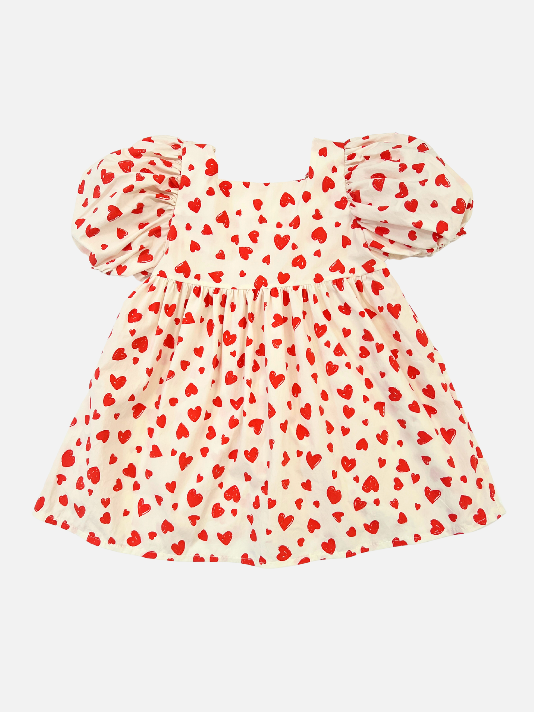 A kids' puff-sleeved dress in a pattern of red hearts on a white background