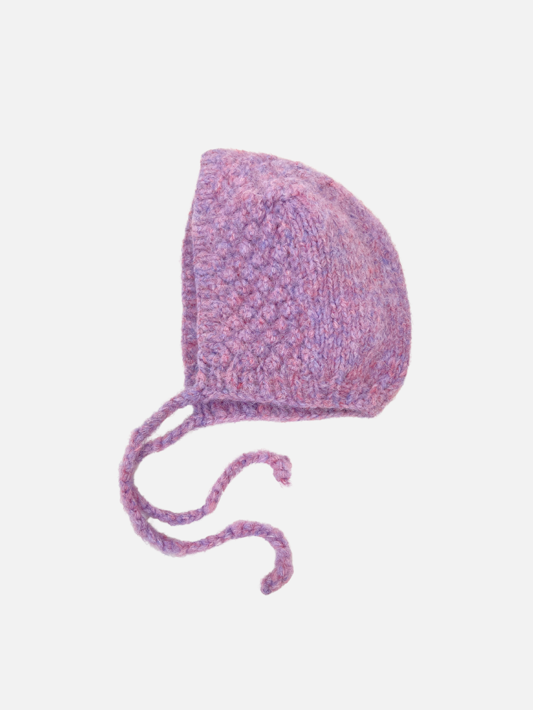 The POPCORN BONNET is a cozy purple knit bonnet with ear flaps and two long ties, featuring a felted texture against a white background.