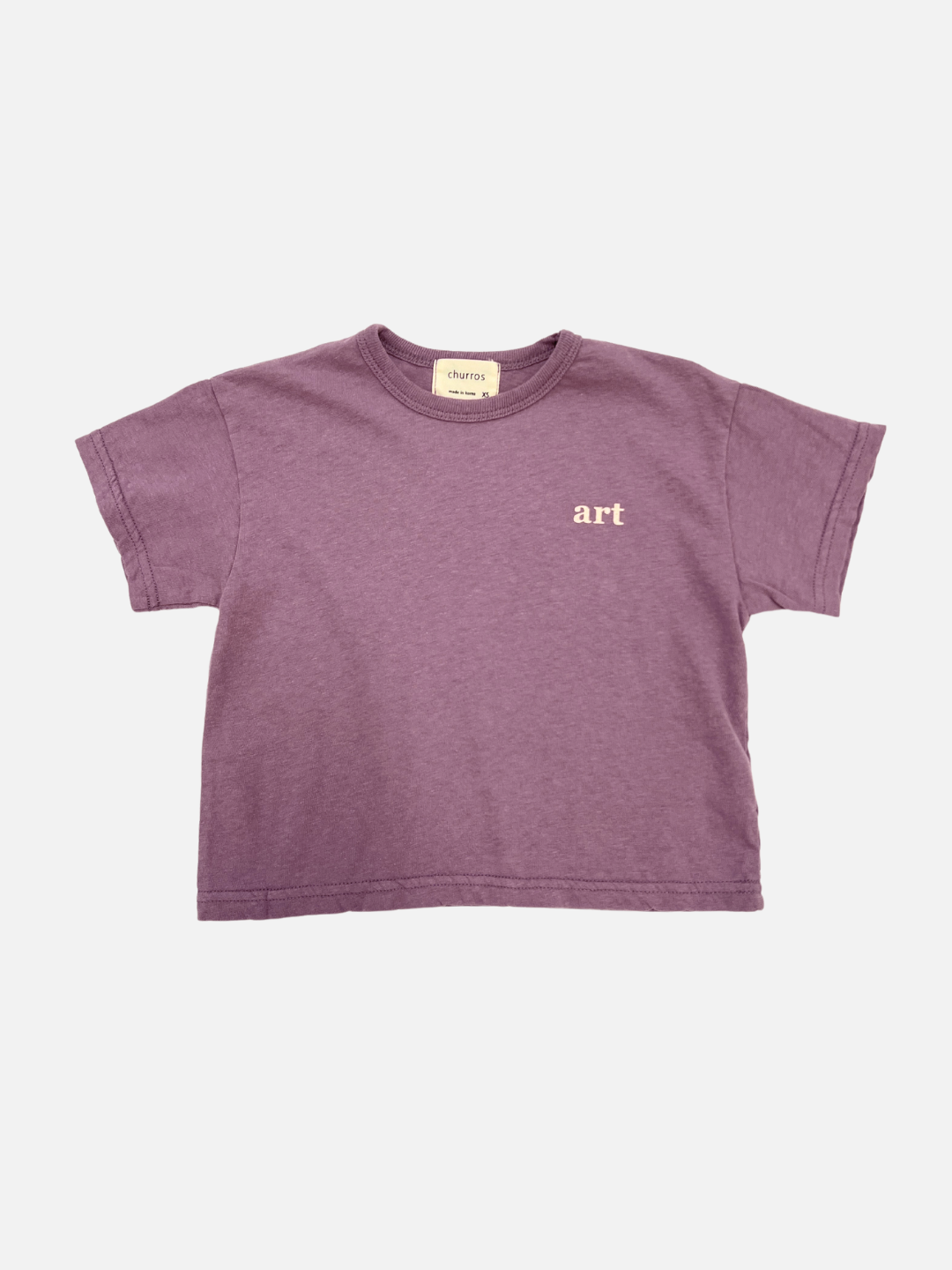 Front view of the kid's Studio tee in mauve, with the words "art" printed on the right side