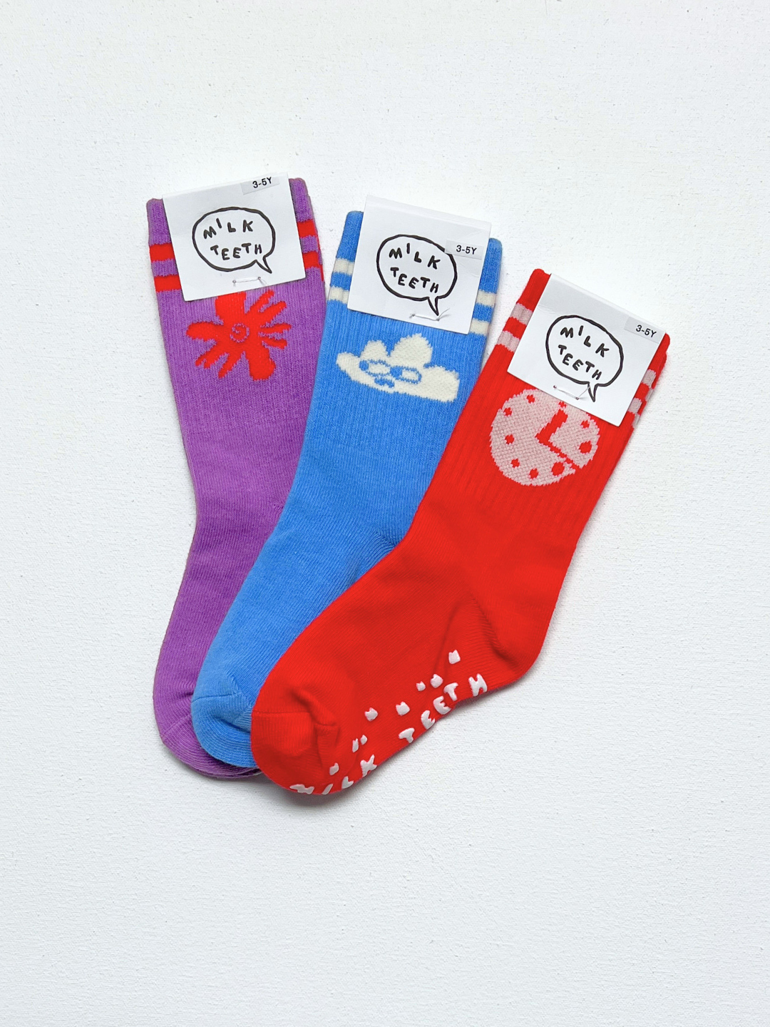 Clock | Three colorful socks with cartoon designs and labels on a white background
