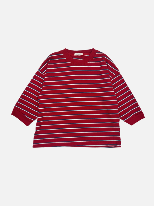 Image of Red | The PEPPER LONGSLEEVE TEE in red, featuring white and navy stripes, is laid flat on a white background; this oversized cotton tee reflects the effortless style of popular Korean kids’ brands.